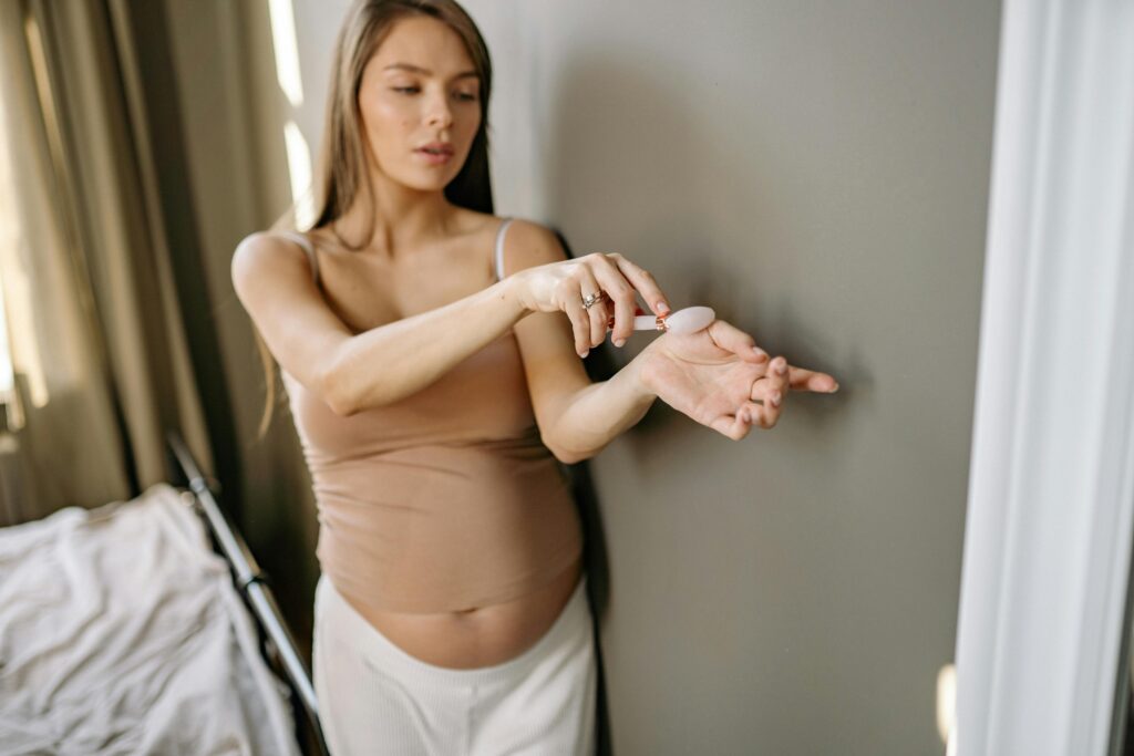 pregnant woman applying retinol